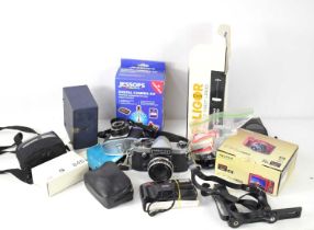 A group of vintage cameras to include Praktica Super TL, Konica C35, Soligor telephoto lens and