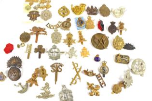 A group of military cap badges including Army Educational Corps, Queen Mary's Army Auxiliary