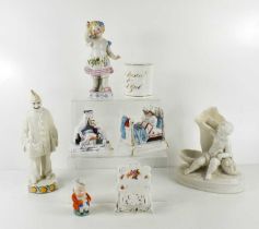 A group of 19th century porcelain, including a figure of a Child proffering a pansy, a figure of