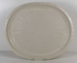 A large Belleek oval dish / platter, embossed all over, with zig-zags emanating from a roundel