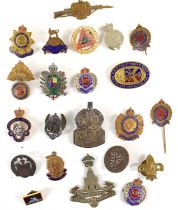 A group of badges and brooches to include a Essex Regiment sweetheart brooch, Green Howards (