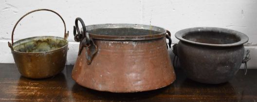 Three antique metal vessels, to include large copper pan with twin handles, a brass jam pan and a
