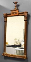 A 19th century wall mirror, with residual gilding, carved with crested top, the rectangular mirror