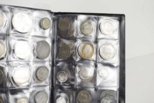 An album of mostly British silver coins to include Queen Victoria shillings, Florins and others.