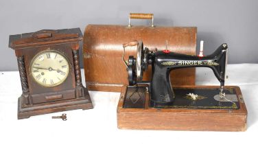 A vintage Singer sewing machine together with a oak cased mantle clock.