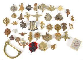 A group of military cap badges including The Royal Electrical and Mechanical Engineers, Royal