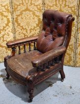 A Victorian library arm chair, with scrolled button back and part upholstered arms, in dark red