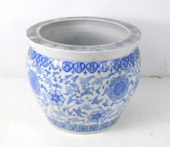 A 20th century Chinese blue and white jardiniere, decorated with flowers, 26.5cm high. [