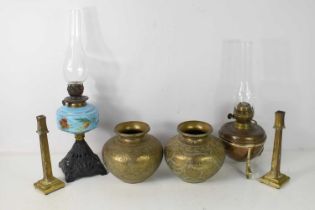 Two antique oil lamps, one example by Duplex, together with a pair of brass column form candlesticks