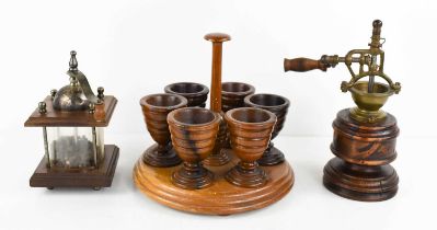 A 19th century treen eggcup stand, with six turned egg cups raised on a circular stepped base,