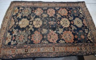 A 19th century Persian rug with blue ground and stylised flowerhead motifs, 82cm by 102cm.