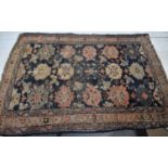 A 19th century Persian rug with blue ground and stylised flowerhead motifs, 82cm by 102cm.