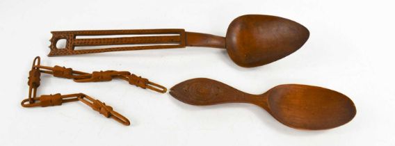 An early 19th century treen Welsh love spoon, the handle pierced and decorated with chip carving,