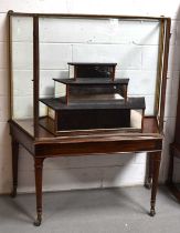 A 19th century glass table display cabinet, the metal upper section with two remaining glass