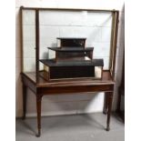 A 19th century glass table display cabinet, the metal upper section with two remaining glass