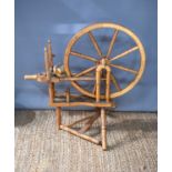 An antique pine spinning wheel, 100cm. [Provenance: The Estate of Cressy Hall, Lincolnshire. This