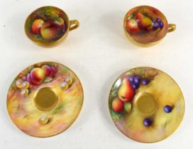 A pair of Royal Worcester cups and saucers hand-painted with fruits, all pieces signed by various