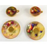 A pair of Royal Worcester cups and saucers hand-painted with fruits, all pieces signed by various