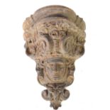 A 19th century cast iron corbel in the form of a face mask within a cartouche, 37cm.