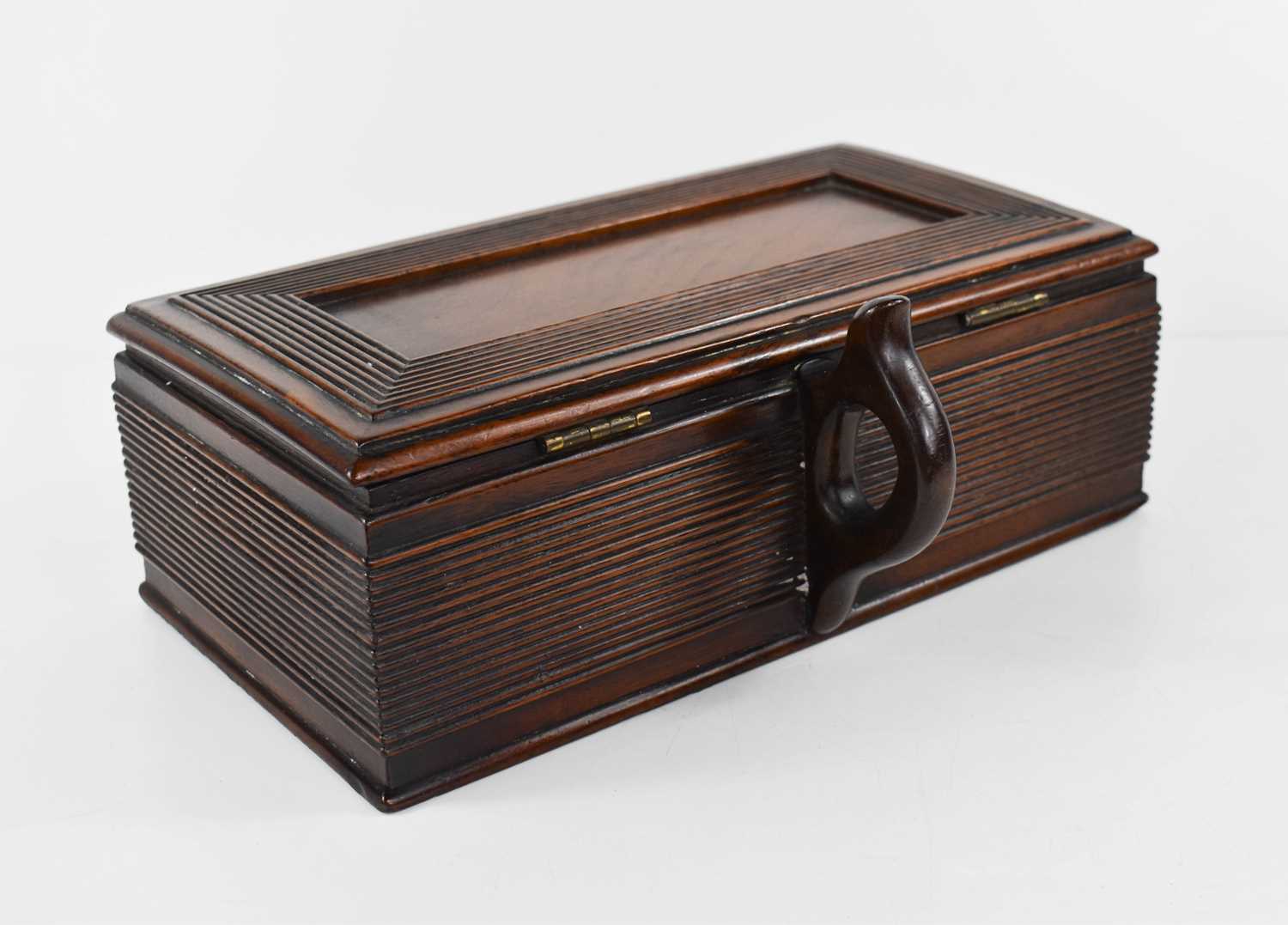 A Georgian mahogany cigar box, with a shaped handle to the back, lid and sides having reeded