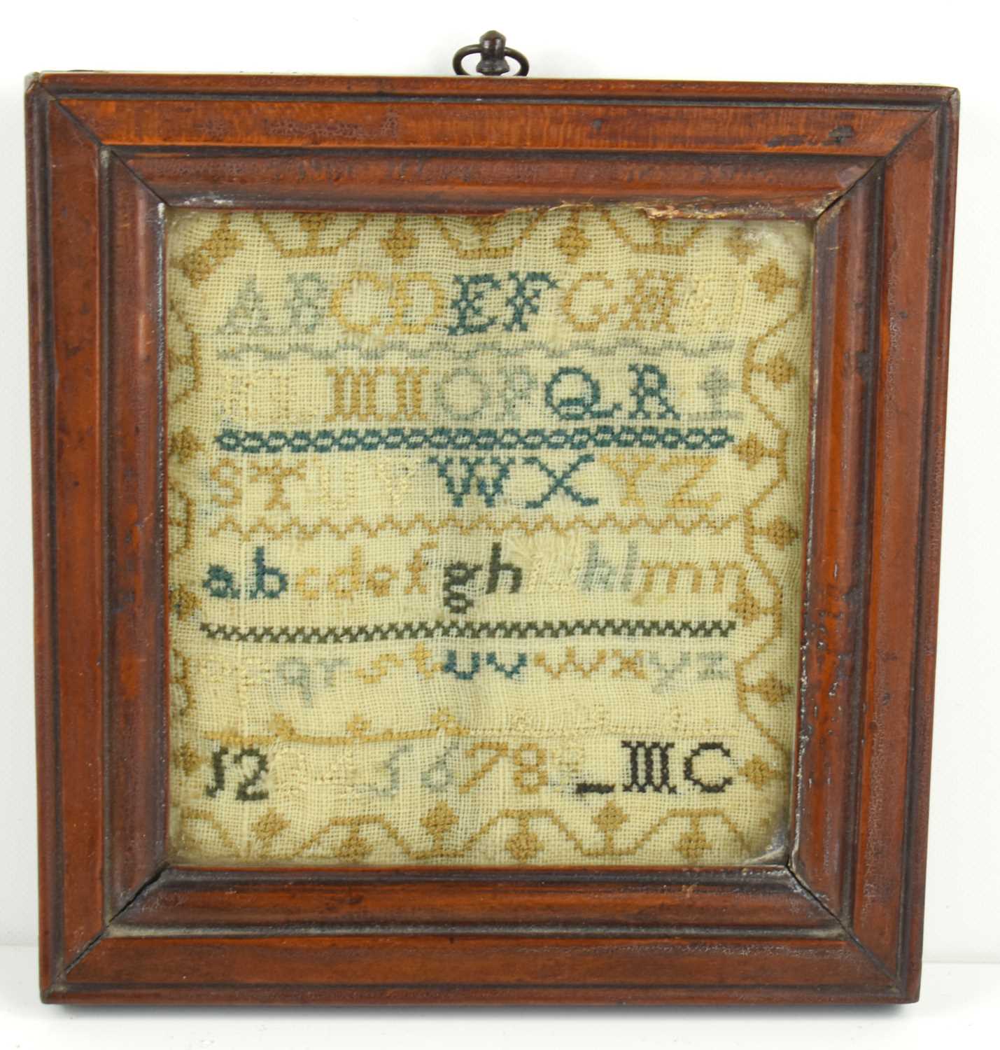 A small Georgian sampler, cross stitch onto a fine hand loomed linen ground, 10.5cm by 11cm.