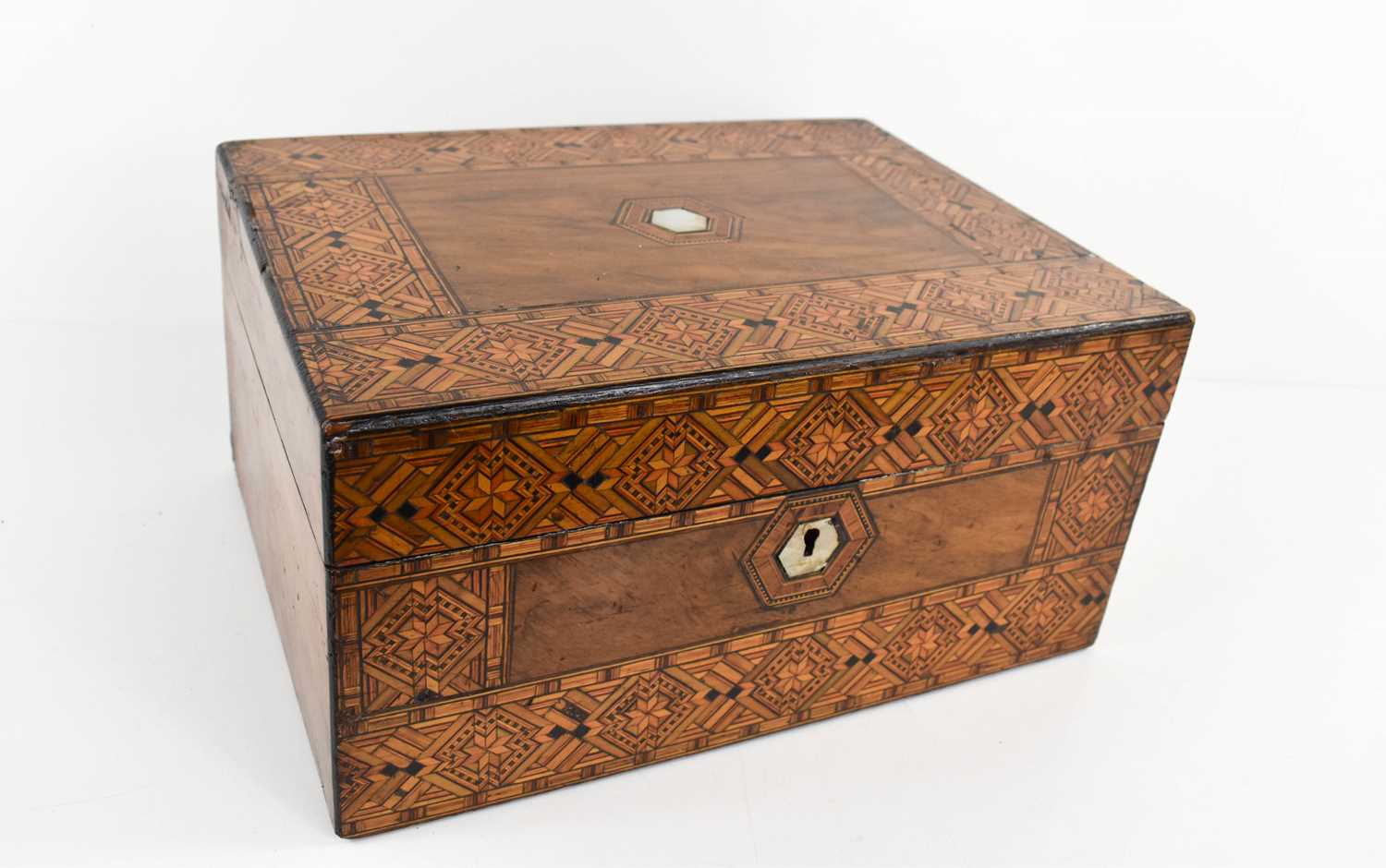 A 19th century Tunbridgeware work box, the lid centred by a hexagonal mother of pearl inlaid plaque,