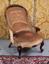 A Victorian mahogany button back nursing chair raised on scroll knop feet with castors.