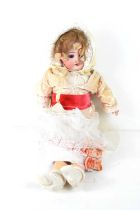 An early 20th century SFBJ Paris doll, bisque head, open and close eyes, jointed limbs and