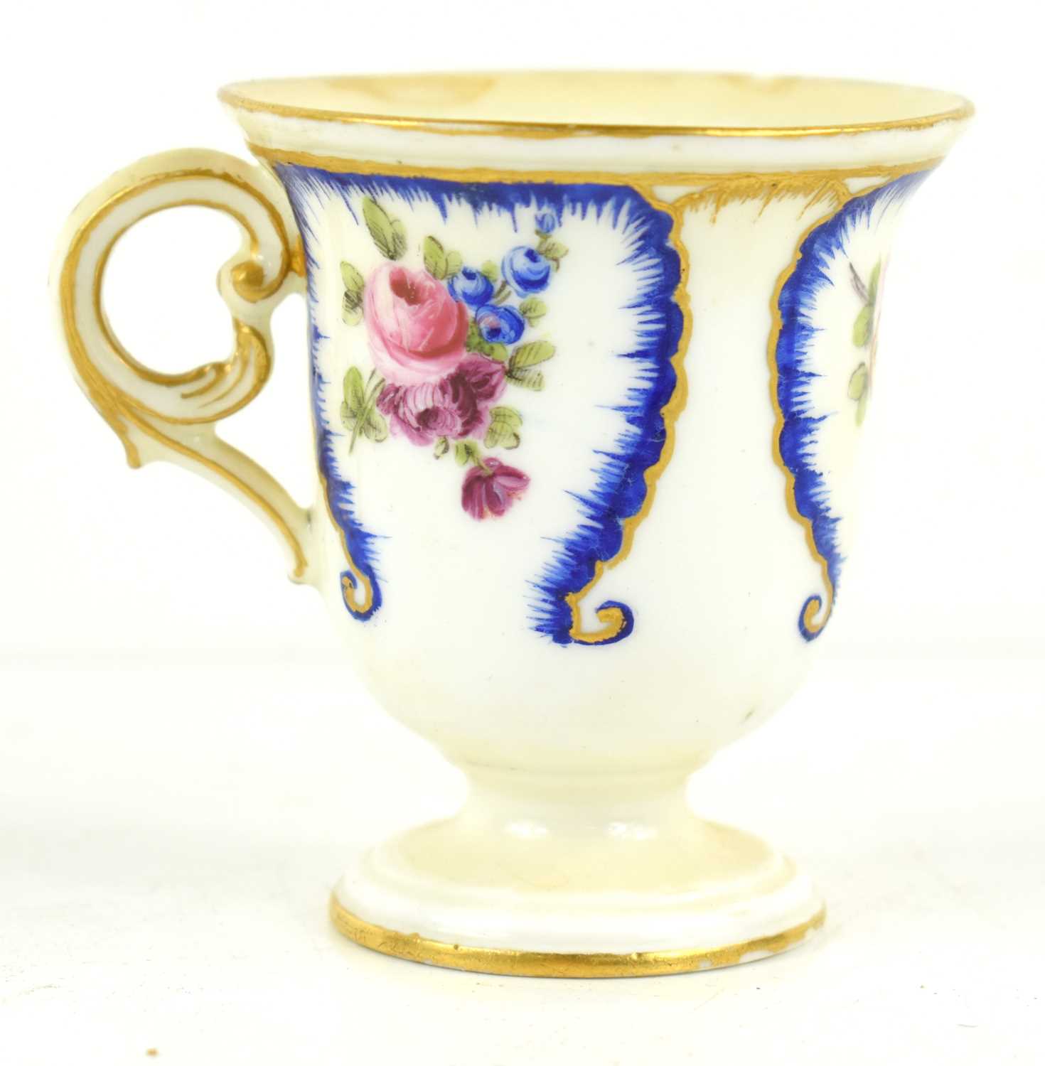 An early 19th century French sorbet cup, manner of Sevres, painted with flowers in blue panels, C