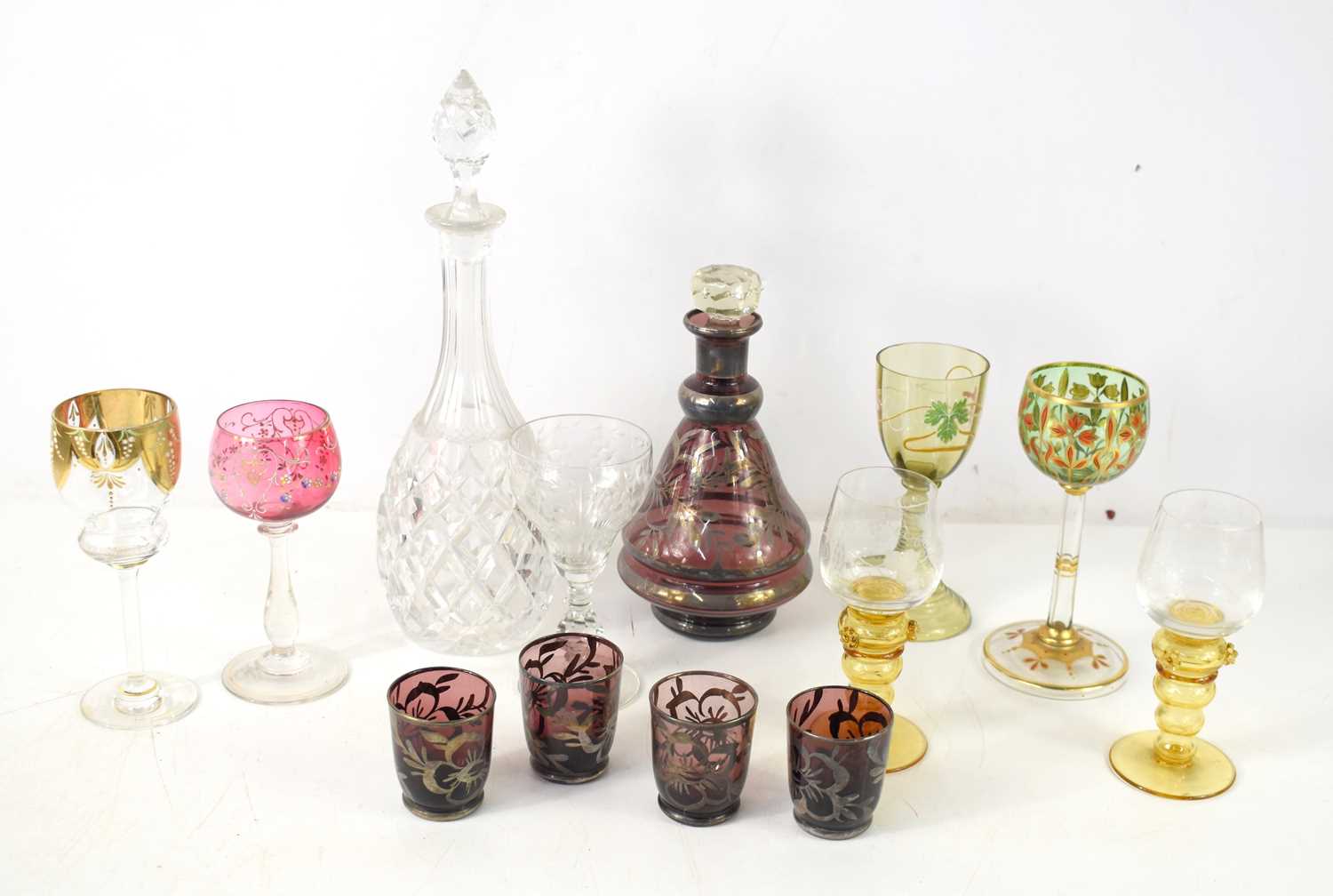 A group of Bohemian drinking glasses to include examples with beehive stems, hock glass with hand