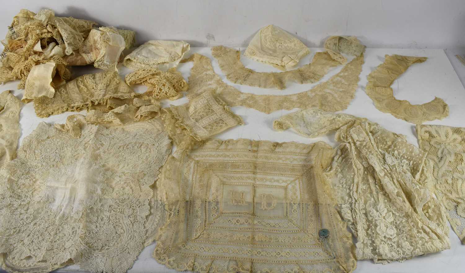 A collection of antique lace and embroidered net to include dress pieces, handkerchiefs, collars,