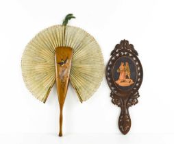 A 19th century treen hand carved hand mirror, likely continental, with marquetry inlaid oval