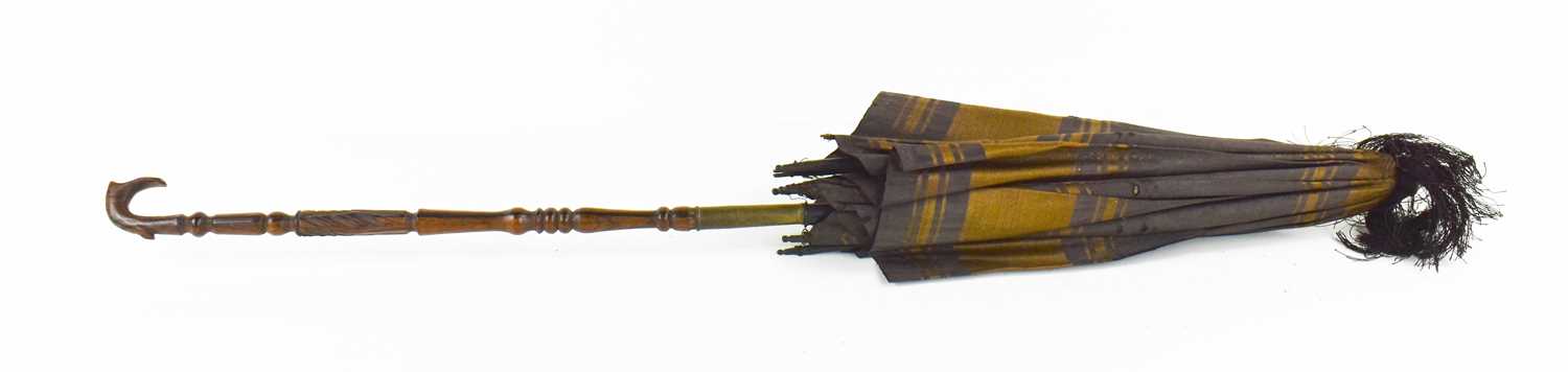 A 19th century childs parasol, the decoratively carved handle in lignum vitae, with silk shade and - Image 2 of 3