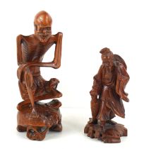 Two Chinese carvings, likely mid 20th century, one as a skeletal figure, 21.5cm high, the other as a