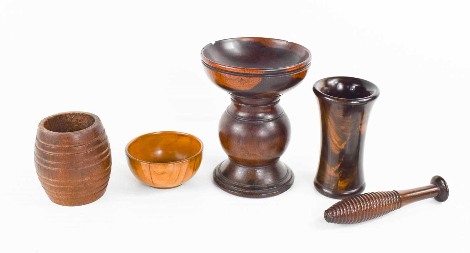 A small apothecaries pestle and mortar, the pestle of reeded form, together with a pedestal lignum