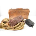 A vintage Gladstone style leather holdall together with a canvas bag and other examples. [