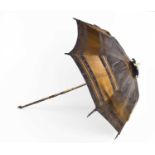 A 19th century childs parasol, the decoratively carved handle in lignum vitae, with silk shade and