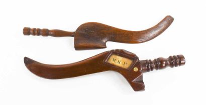 Two 19th century goose wing knitting sheaths, one in oak, and the other bearing an aperture with