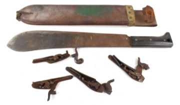 A WWII army issued machete housed in leather scabbard together with a group of flintlock firing