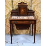 An Edwardian rosewood ladies work table, the raised back having a single cupboard door flanked by