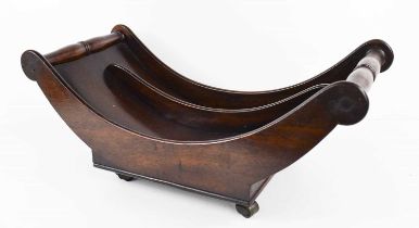 A Georgian mahogany cheese dish, the shaped sides united with turned rails, and raised on original