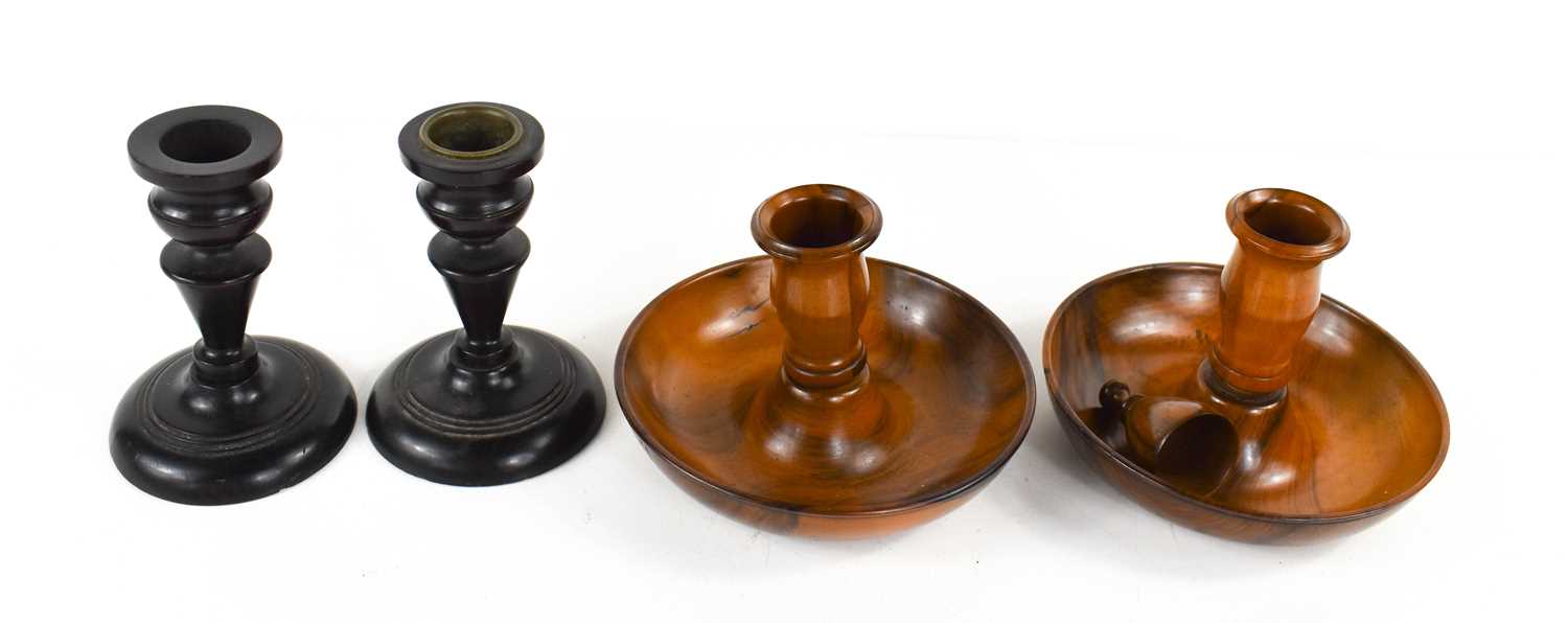 A pair of late 18th / early 19th century lignum vitae candle holders, with screw on candle