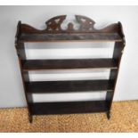 A 19th century mahogany wall shelf, the shaped and pieced back rail adjoining two shaped side panels