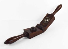 A treen fruit press, likely rosewood, the two turned handles adjoin the hinged blocks, one side with