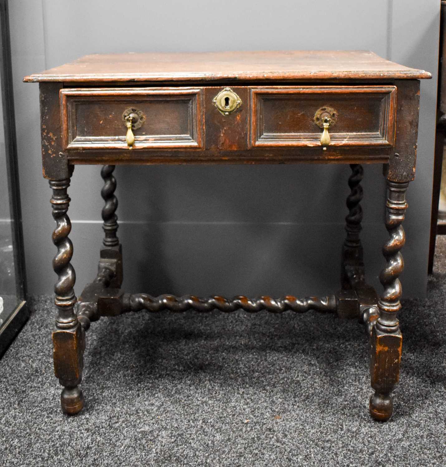 A 17th century oak side table with single drawer, barley twist legs and H form stretcher, top