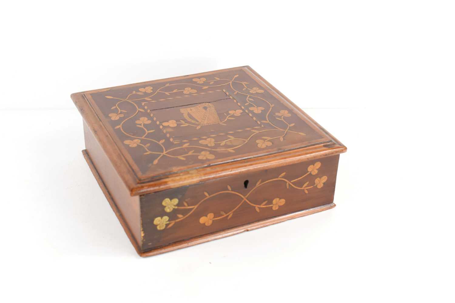 A 19th century marquetry inlaid box, the lid depicting a harp surrounded by floral sprays, 22cm by