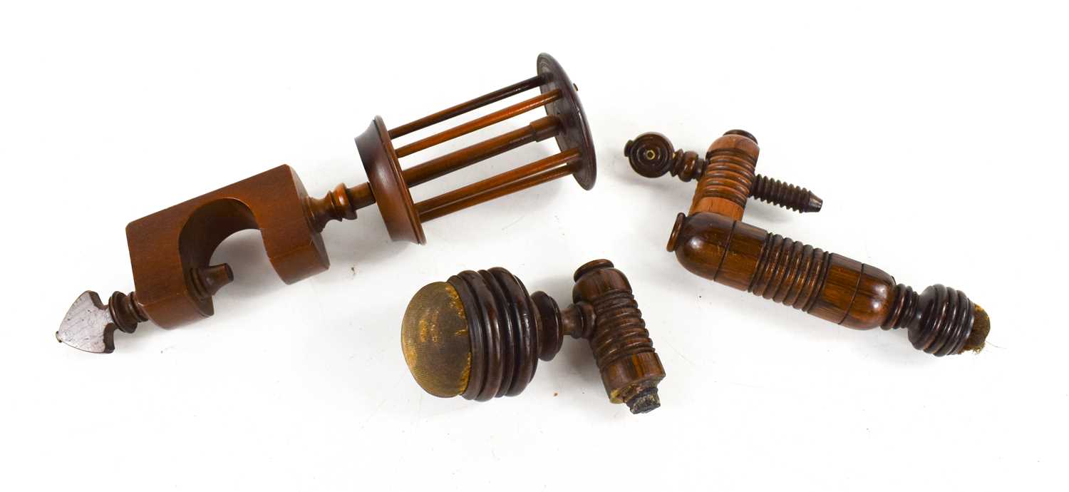 An Early yew wood silk winder, circa 1820, together with two rosewood table clamp pin and needle