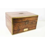 A 19th century rosewood travelling vanity case, with brass inset handles, the fitted interior