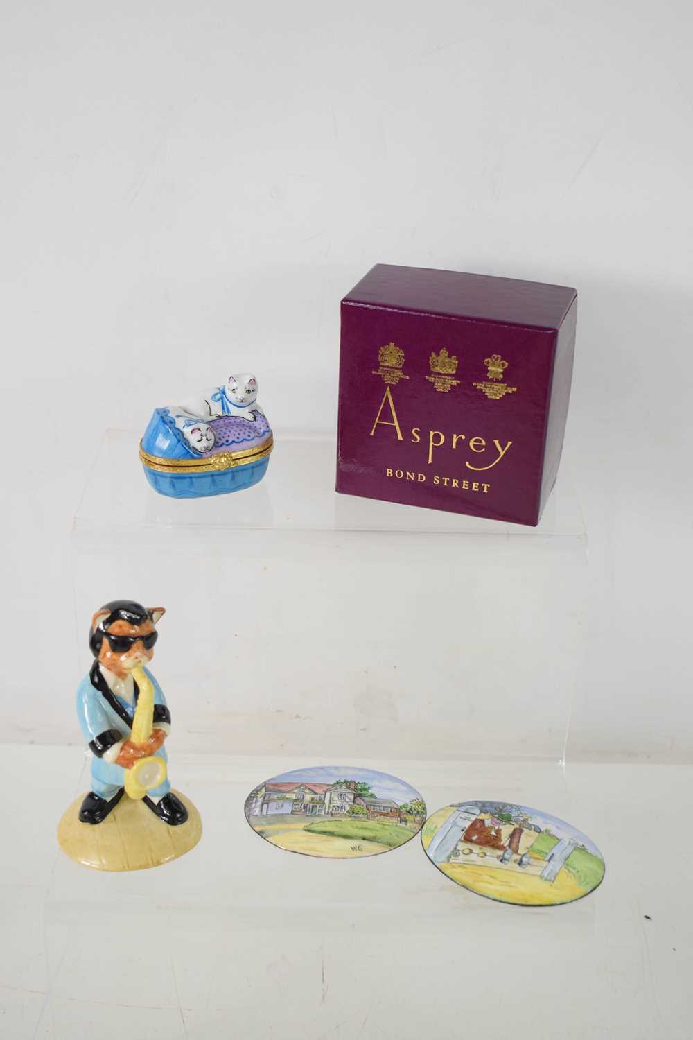 A Limoges Asprey porcelain pill box in the form of two cats in a basket, with the original box,