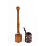 A 19th century treen potato masher, with a turned handle, and a lignum vitae mortar and matching